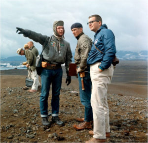 Astronaut Dave Scott pointing out a geologic feature to astronaut Gene Cernan and Elbert A. King on the rim of the Askja Caldera